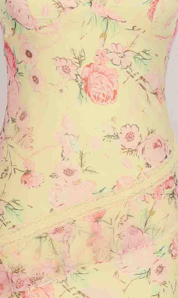 Close-up of the Long Prom Dress: PromGirl Exclusive 250280 fabric, displaying light yellow with pink floral print and diagonal lace trim detail.